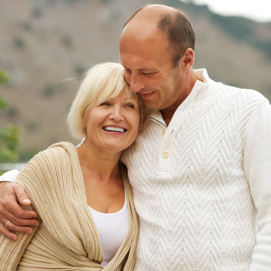 Older couple smiling together outdoors