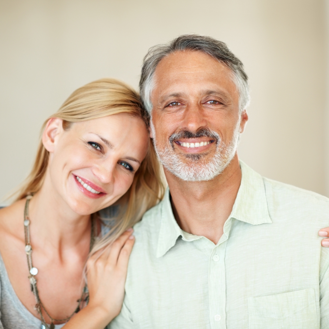 Smiling couple with healthy natural-looking teeth