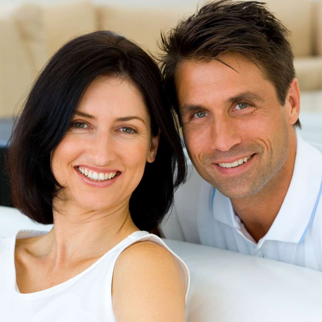 Couple smiling confidently at home