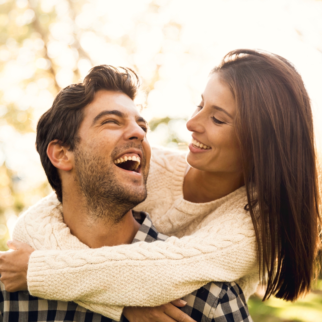Couple laughing together outdoors