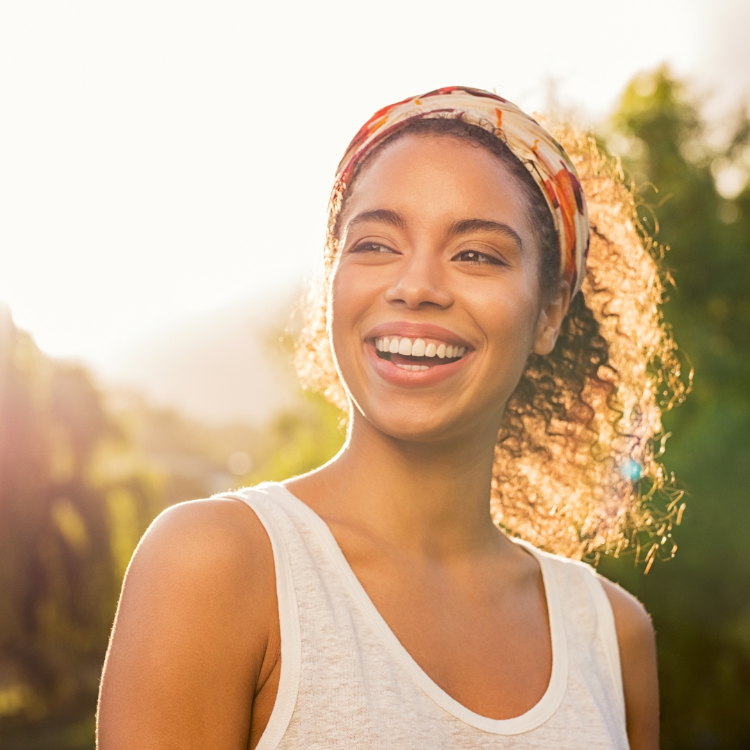 Woman smiling confidently in sunlight